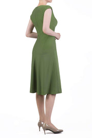 model wearing diva catwalk rochelle swing skirt a line dress without sleeves with a low v neck in apple green side 