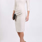 Model wearing the Seed Agatha in pencil dress design in sandy cream front image