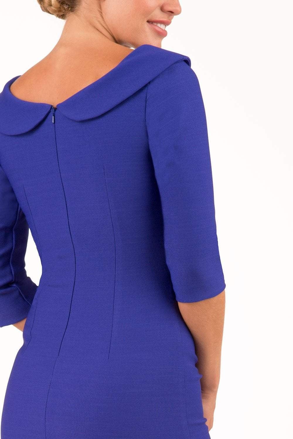 model is wearing diva catwalk seed axford pencil sleeved dress with rounded folded collar in palace blue back close up