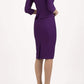 Brunette Model is wearing a three quarter sleeve couture seed pencil dress frill side detail by Diva Catwalk in purple back