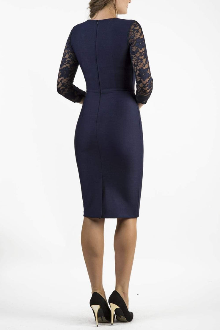 Brunetter Model is wearing seed couture lace pencil dress by diva catwalk in navy  back