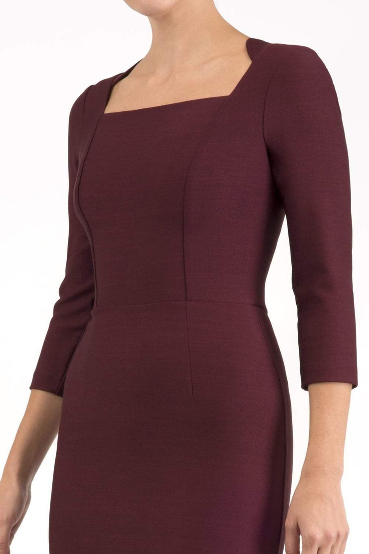 model is wearing seed rowena pencil dress with sleeves and square neckline in port royale front close up