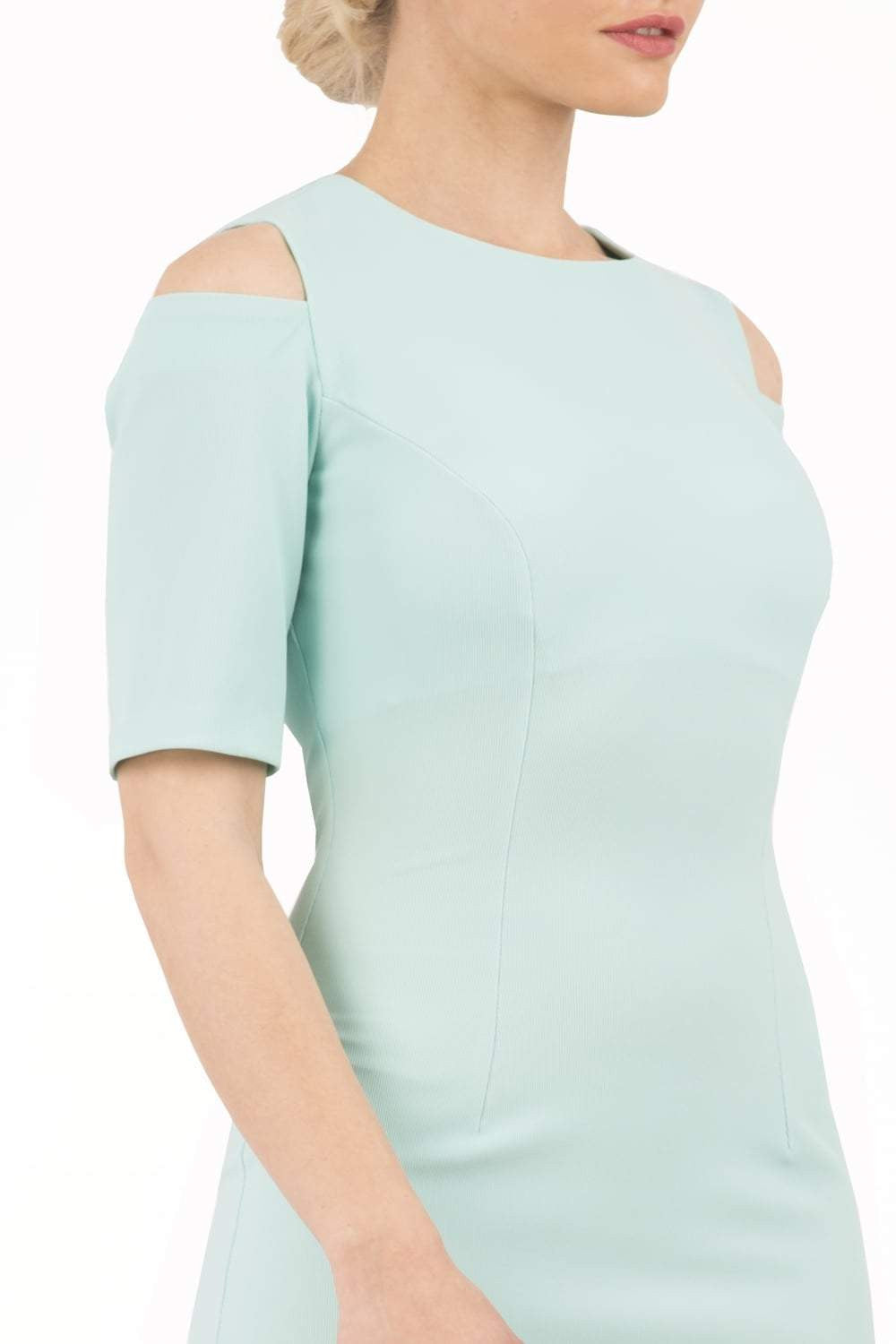 model is wearing diva catwalk solway pencil dress cold shoulder detail and rounded neckline in mint green front close up