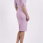 brunette model wearing diva catwalk tryst pencil pale pink dress with sleeves and belt detail at the front with rounded neckline back